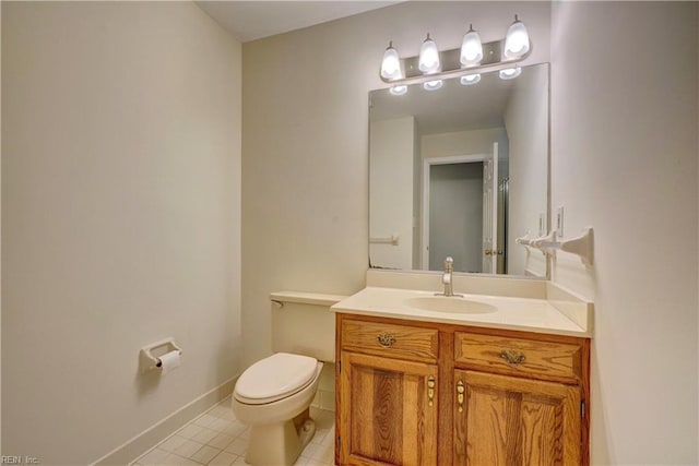 bathroom with tile patterned floors, vanity, and toilet