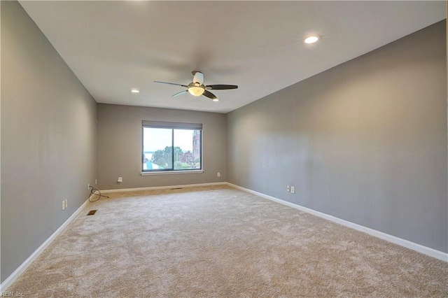 unfurnished room featuring light carpet and ceiling fan