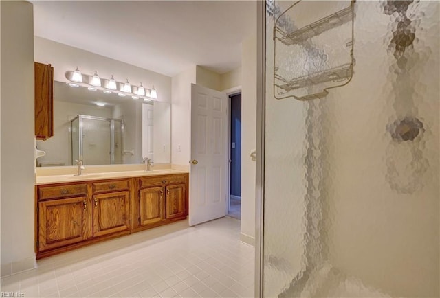 bathroom with tile patterned flooring, vanity, and a shower with door