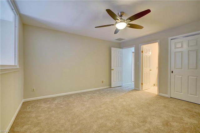 unfurnished bedroom with ceiling fan and light colored carpet