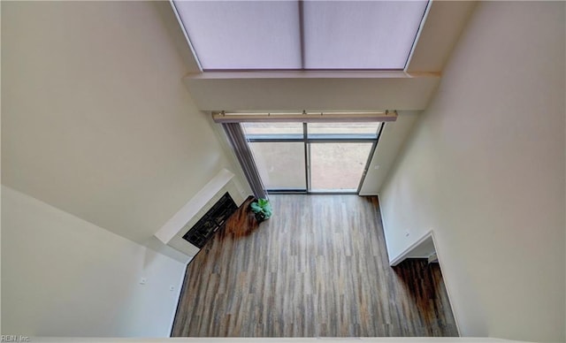 unfurnished living room with wood-type flooring and a high ceiling