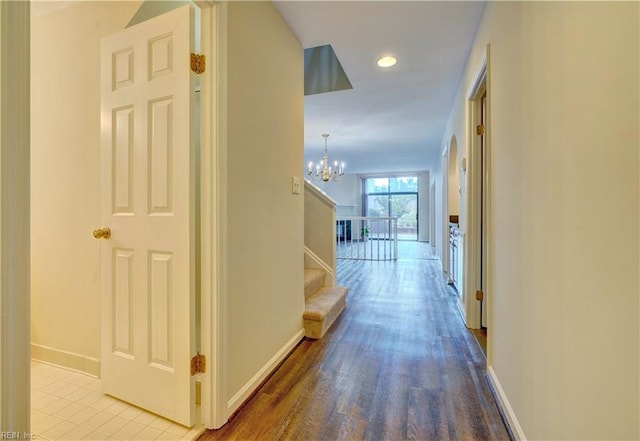 hallway featuring light hardwood / wood-style flooring and a notable chandelier