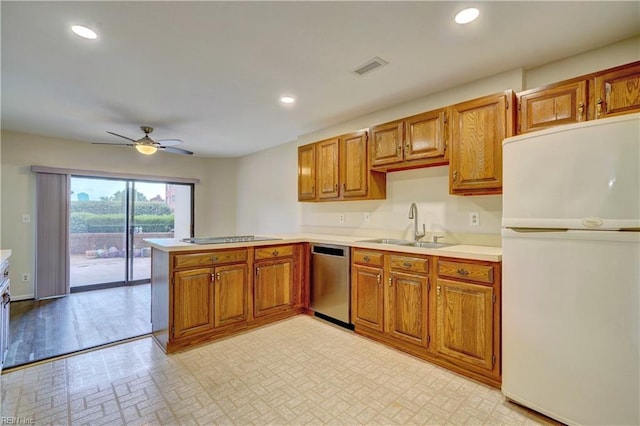 kitchen featuring kitchen peninsula, stainless steel dishwasher, ceiling fan, sink, and white refrigerator