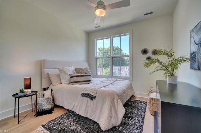 bedroom with light hardwood / wood-style flooring and ceiling fan