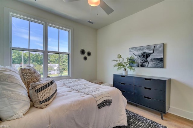 bedroom with light hardwood / wood-style floors and ceiling fan