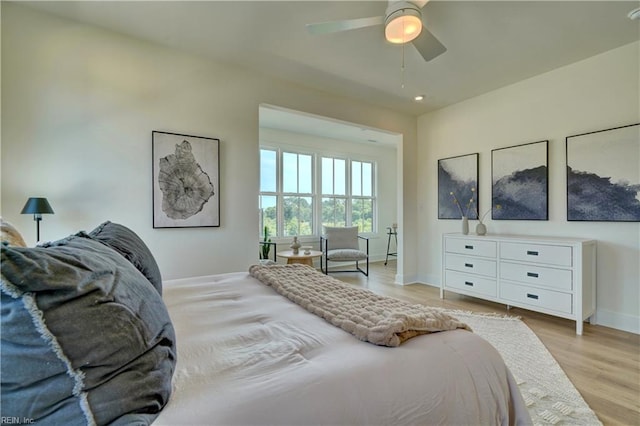 bedroom with light wood-type flooring and ceiling fan