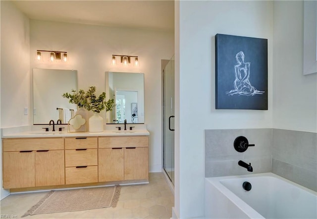 bathroom with tile patterned flooring, vanity, and separate shower and tub