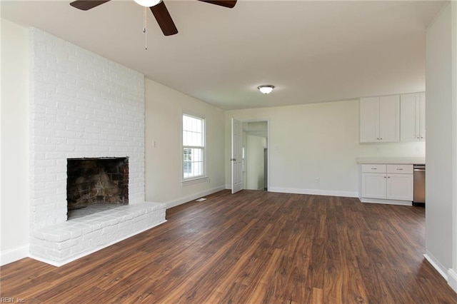 unfurnished living room featuring dark hardwood / wood-style floors, ceiling fan, and a fireplace