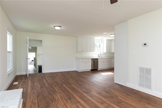 unfurnished living room with sink and dark wood-type flooring