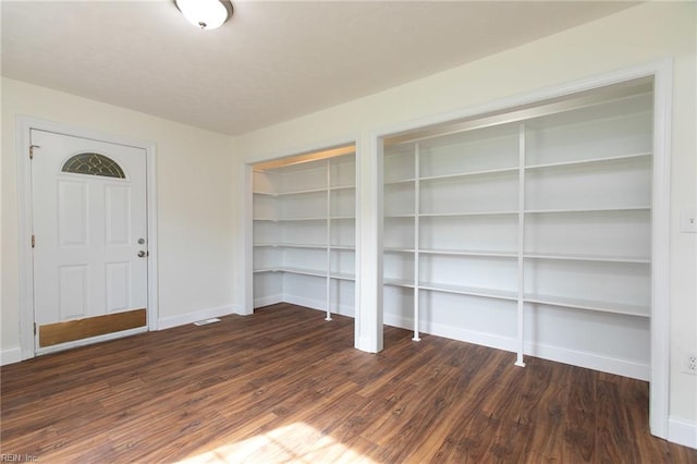 entryway with dark hardwood / wood-style flooring