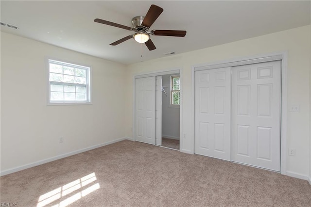 unfurnished bedroom with ceiling fan and light carpet