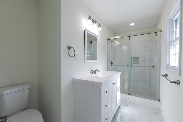 bathroom with an enclosed shower, vanity, and toilet