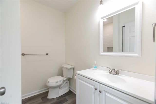 bathroom with vanity, hardwood / wood-style flooring, and toilet