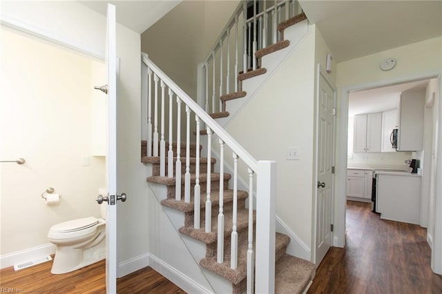 stairway featuring hardwood / wood-style flooring