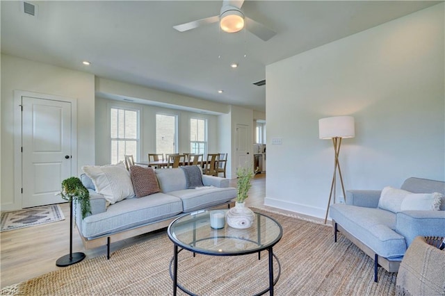 living room featuring ceiling fan and light wood-type flooring