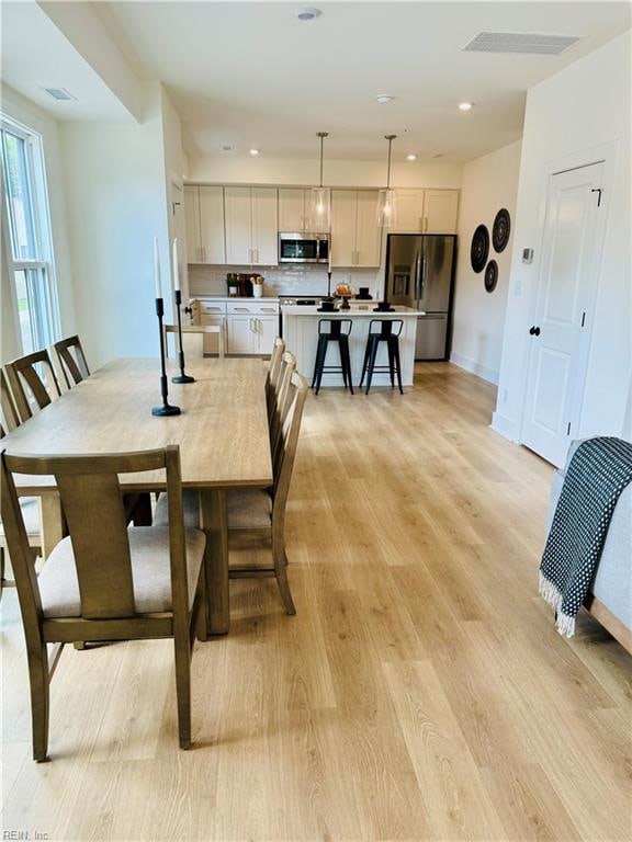 dining area with light hardwood / wood-style flooring