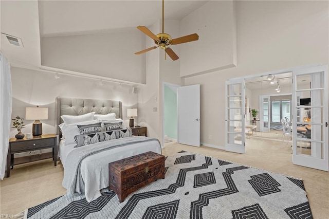 carpeted bedroom featuring french doors, high vaulted ceiling, and ceiling fan