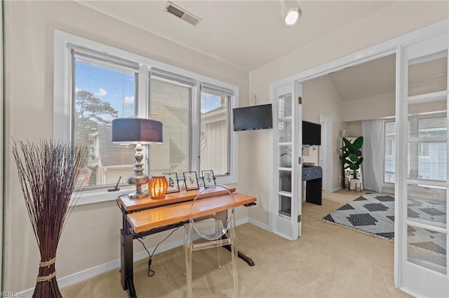 carpeted office with lofted ceiling