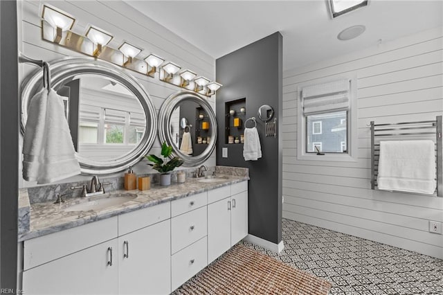 bathroom featuring vanity, wood walls, and radiator