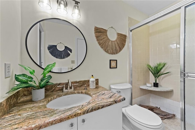 bathroom with vanity, toilet, and an enclosed shower