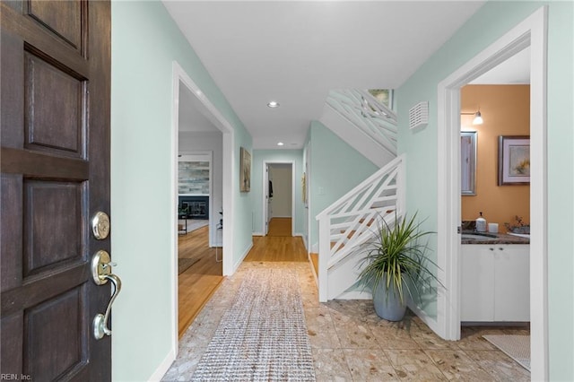 foyer entrance featuring sink and light hardwood / wood-style flooring