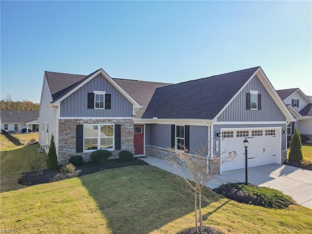 craftsman inspired home featuring a front yard and a garage