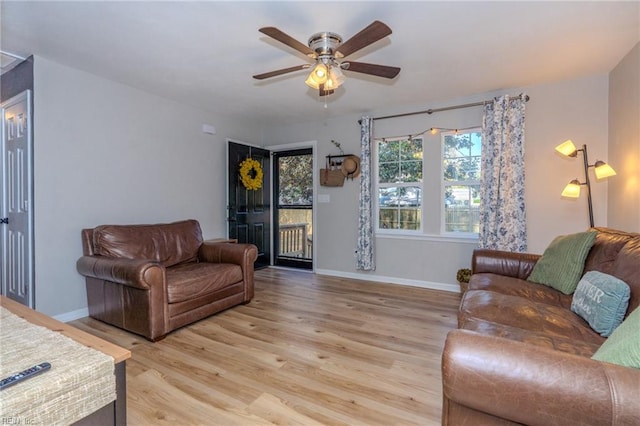 living room featuring ceiling fan and light hardwood / wood-style floors