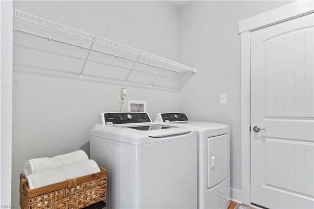 washroom with washing machine and clothes dryer