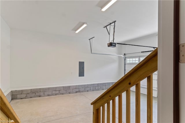 garage featuring electric panel and a garage door opener