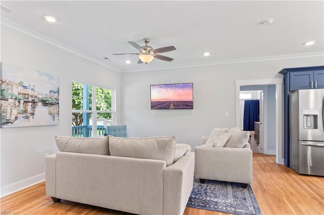 living room featuring ceiling fan, light wood-type flooring, and ornamental molding