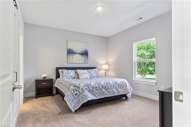 bedroom with light colored carpet