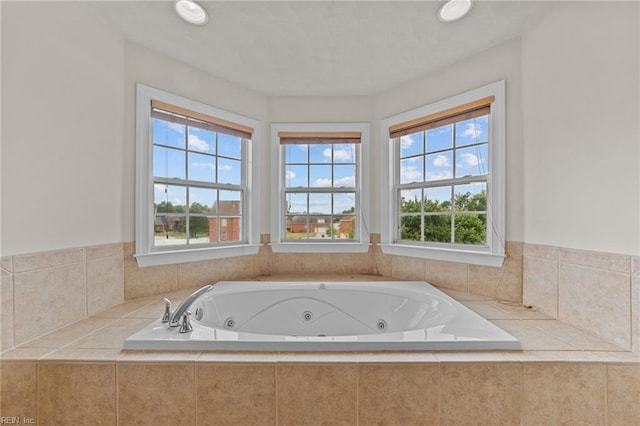 bathroom with a relaxing tiled tub and a wealth of natural light