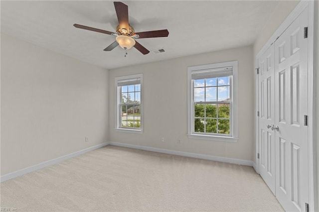 unfurnished bedroom with ceiling fan and light carpet