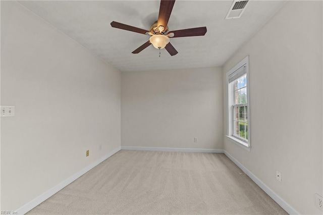 empty room featuring ceiling fan and light colored carpet