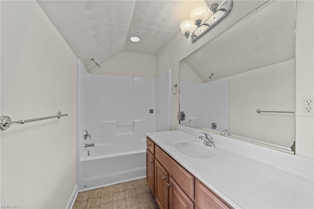 bathroom with  shower combination, vanity, and vaulted ceiling