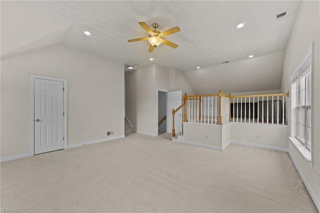 carpeted spare room featuring ceiling fan and lofted ceiling