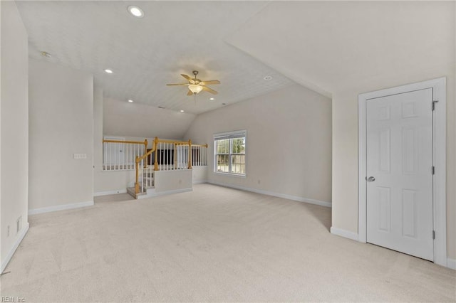 unfurnished living room featuring light colored carpet, ceiling fan, and lofted ceiling