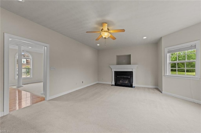 unfurnished living room with ceiling fan and light colored carpet