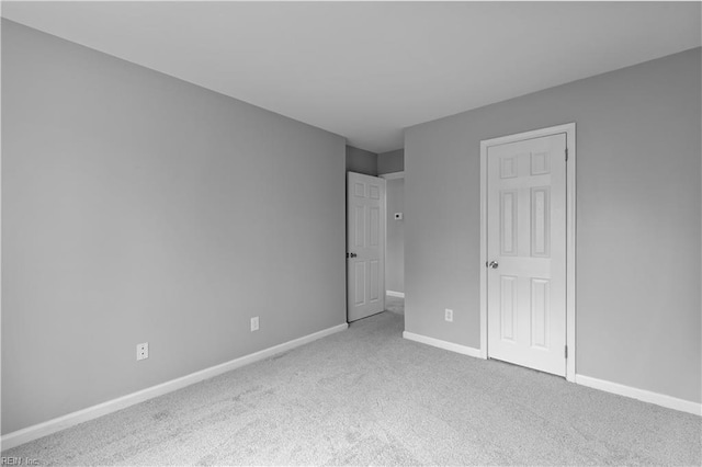 unfurnished bedroom featuring light carpet