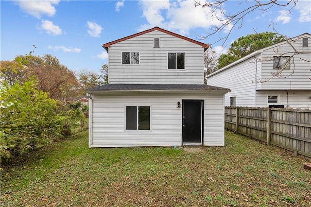 back of house featuring a yard