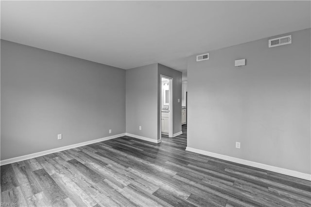 spare room featuring dark hardwood / wood-style flooring