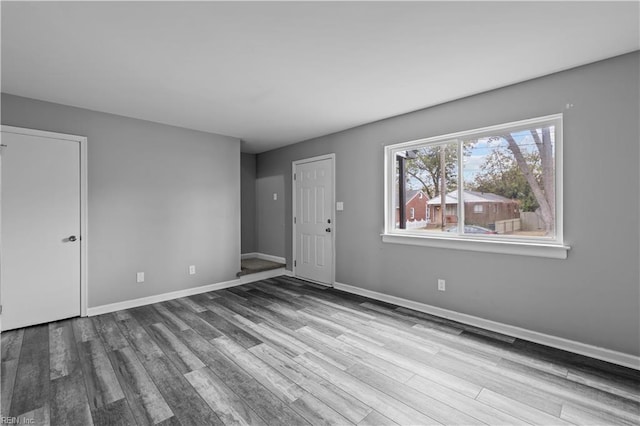 empty room with light hardwood / wood-style flooring