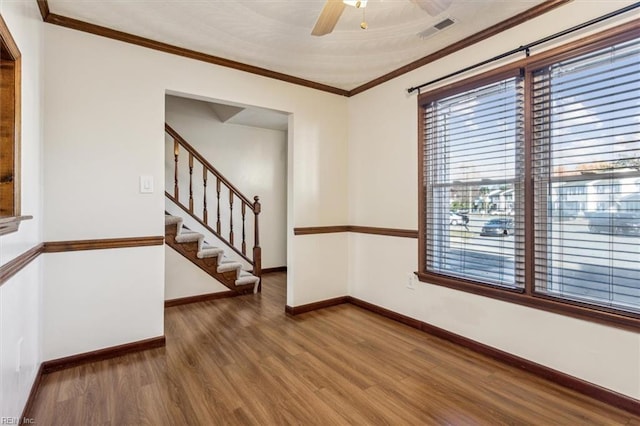 unfurnished room featuring ceiling fan, dark hardwood / wood-style flooring, and ornamental molding