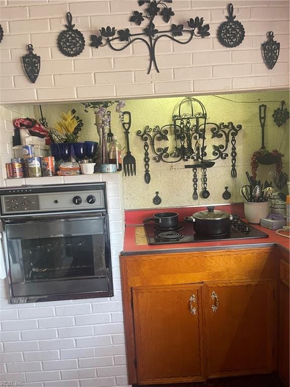 kitchen featuring black electric stovetop and wall oven