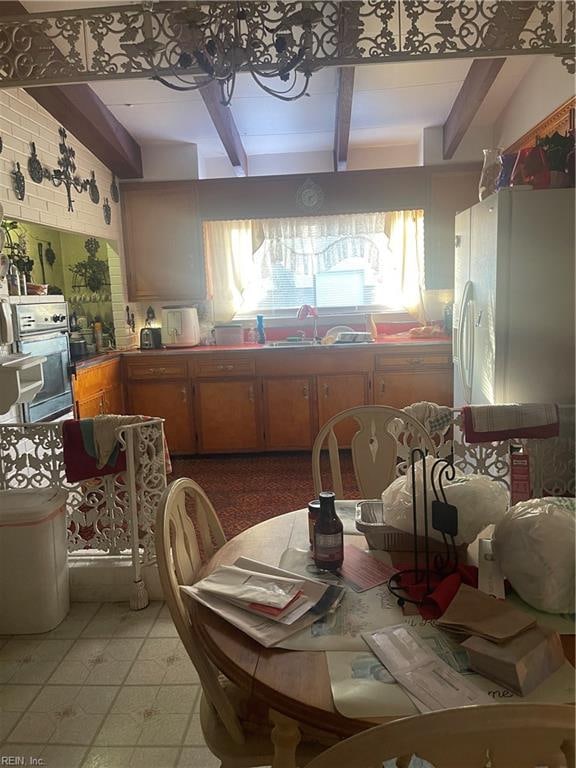 kitchen featuring white fridge, sink, and oven