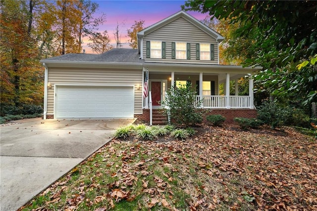 view of front of house featuring covered porch and a garage