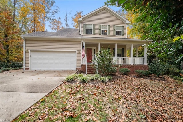 view of property with covered porch and a garage