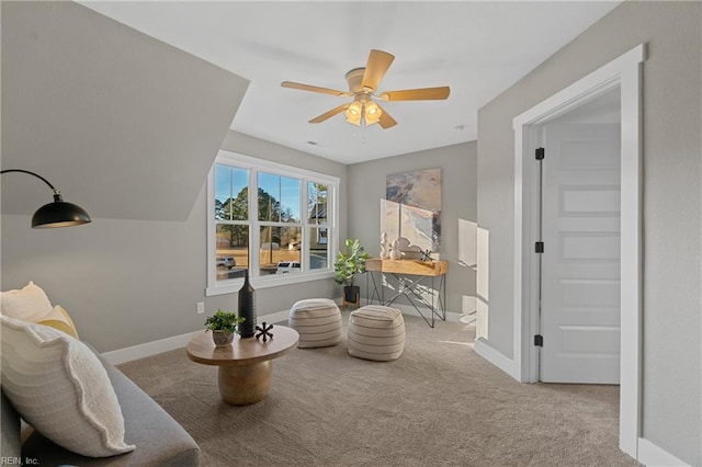 sitting room featuring light colored carpet and ceiling fan