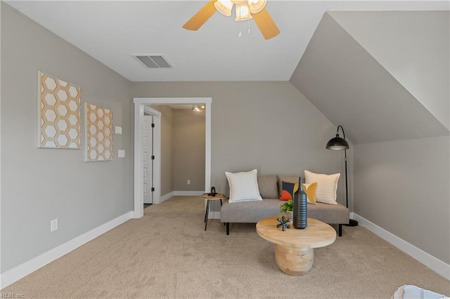 living area featuring ceiling fan, light carpet, and vaulted ceiling