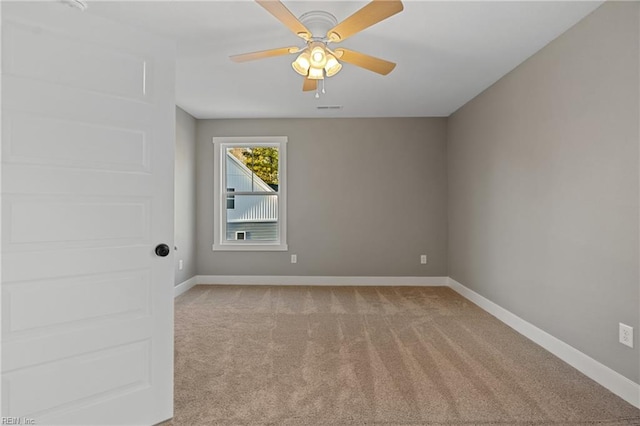 carpeted spare room with ceiling fan